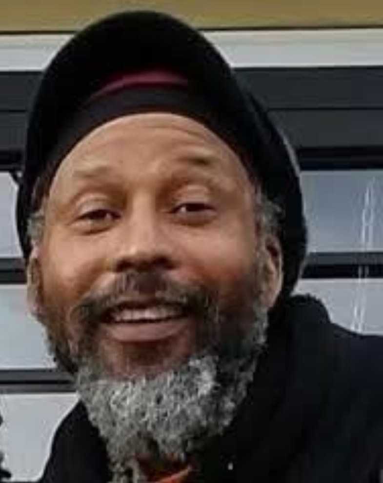 Leroy Fullwood smiling, wearing a dark cap